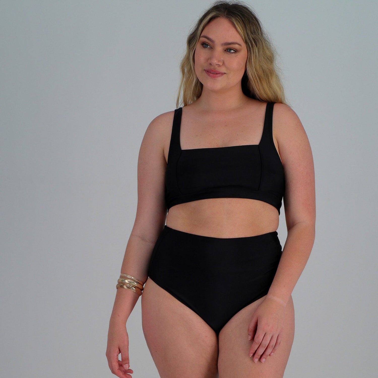 Model wearing the black Kachi bikini top by Loyde Triana – clean, minimalist design with medium support